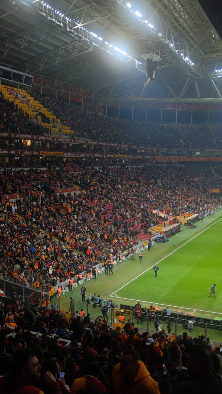 A lively soccer game with enthusiastic crowd at a major Istanbul stadium.