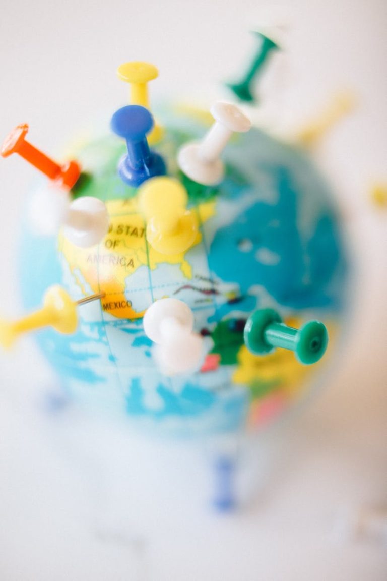 A vibrant globe with colorful pins marking destinations, symbolizing travel plans.